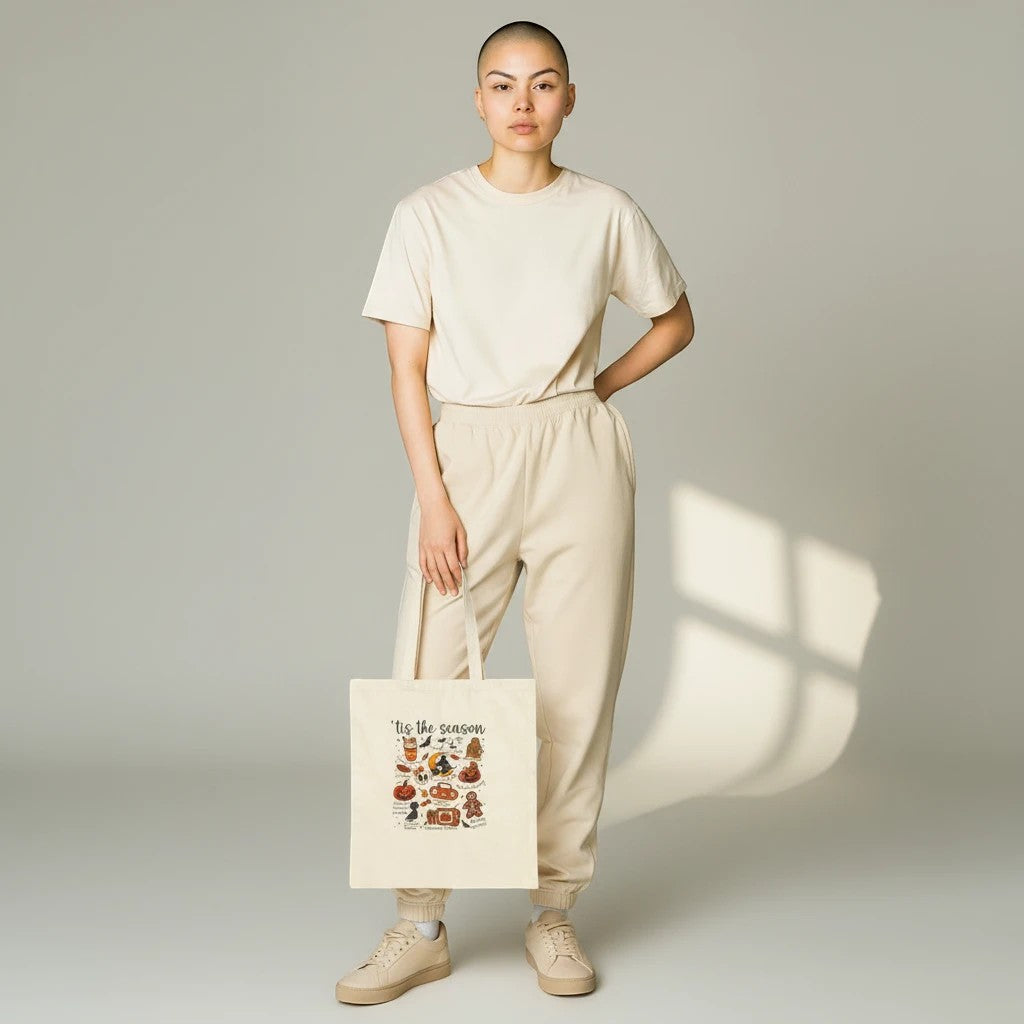 Sea Dragon Dreams natural cotton canvas tote bag with Halloween print held by a model in matching beige loungewear.