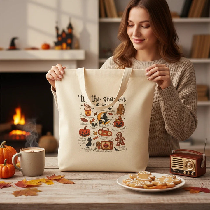 Sea Dragon Dreams natural cotton canvas tote bag with festive Halloween illustrations held by a smiling woman