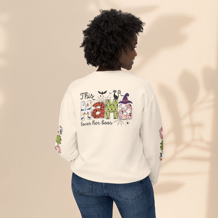 Sea Dragon Dreams cream crewneck sweatshirt with This Mama Loves Her Boos Halloween print on back, worn by a woman.