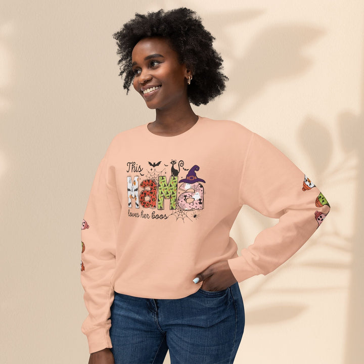 Sea Dragon Dreams peach crewneck sweatshirt with This Mama Loves Her Boos Halloween graphic and sleeve print.