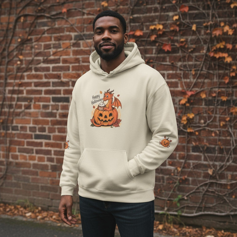 A man wearing a Sea Dragon Dreams cream-colored hoodie with a playful dragon and pumpkin Halloween graphic.