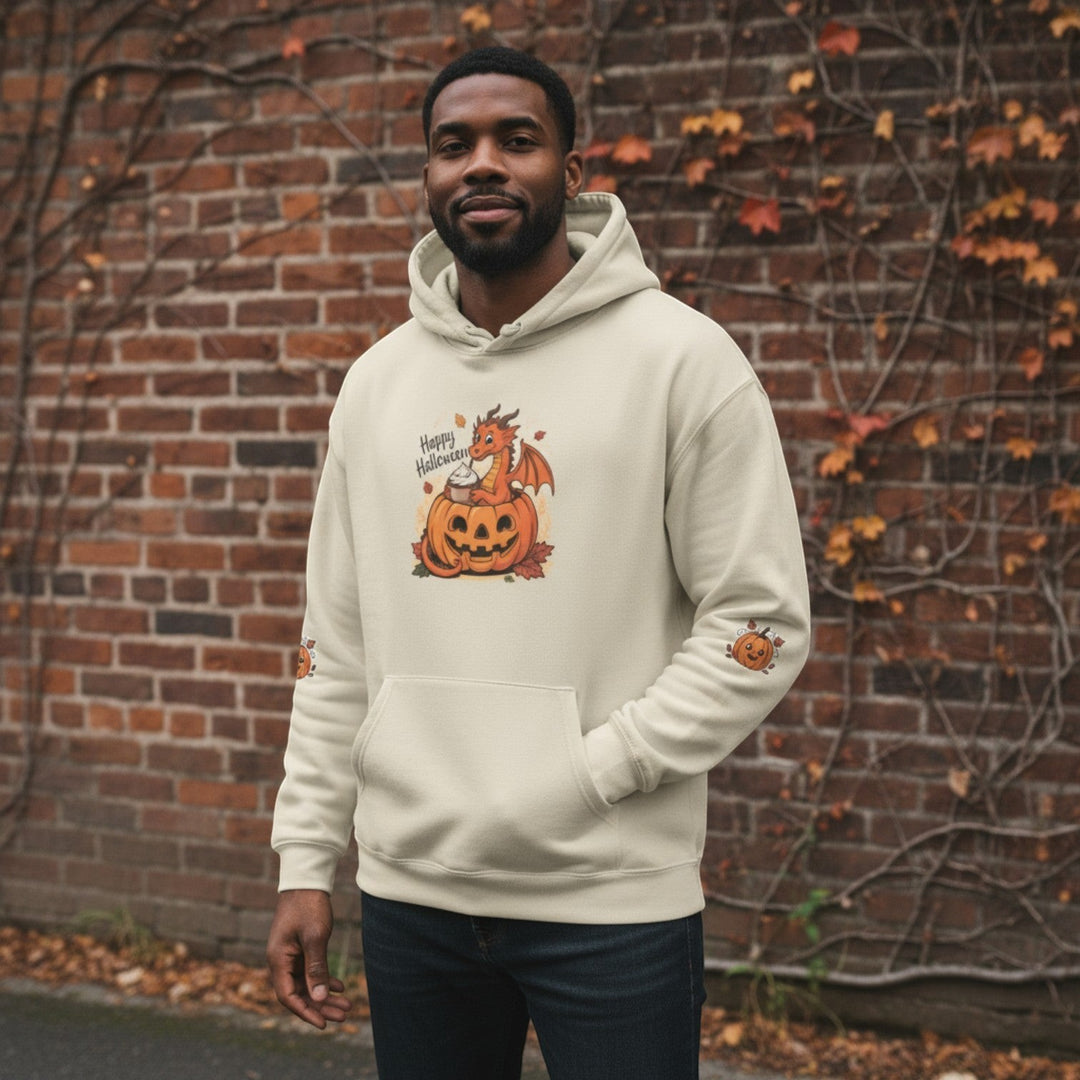 A man wearing a Sea Dragon Dreams cream-colored hoodie with a playful dragon and pumpkin Halloween graphic.