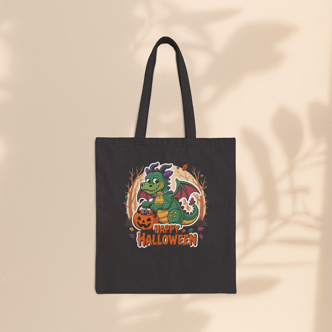 Sea Dragon Dreams black cotton canvas tote bag featuring a cute green dragon with a pumpkin for Halloween trick-or-treating