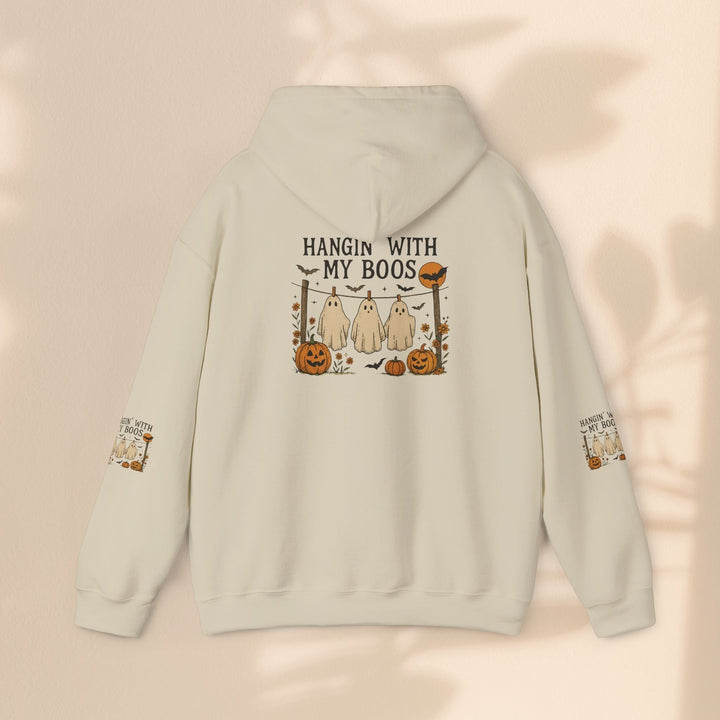 Sea Dragon Dreams cream-colored Halloween hoodie with a ghost and pumpkin graphic on the back and sleeve details.