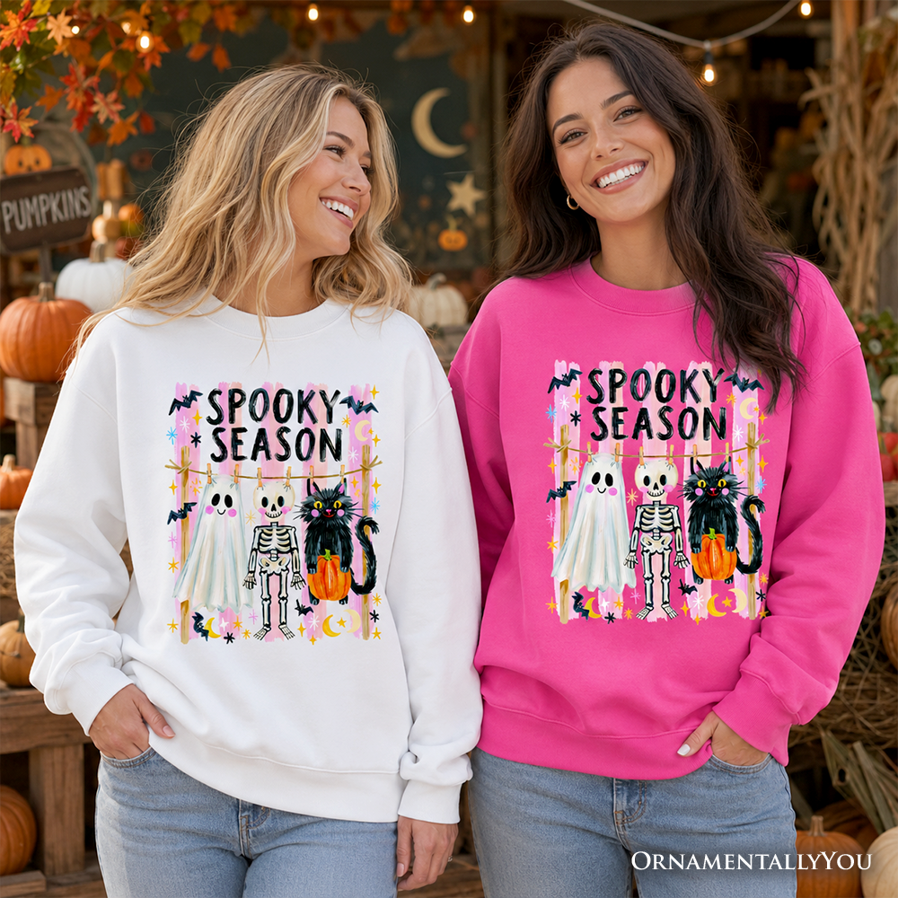Sea Dragon Dreams Spooky Season sweatshirt with ghost, skeleton, and cat print on white and pink crewneck sweaters