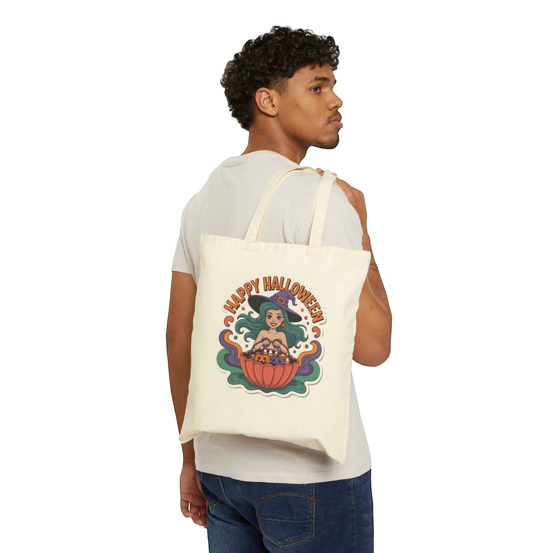 Sea Dragon Dreams cotton canvas tote bag featuring a witch mermaid graphic, worn over the shoulder by a man.