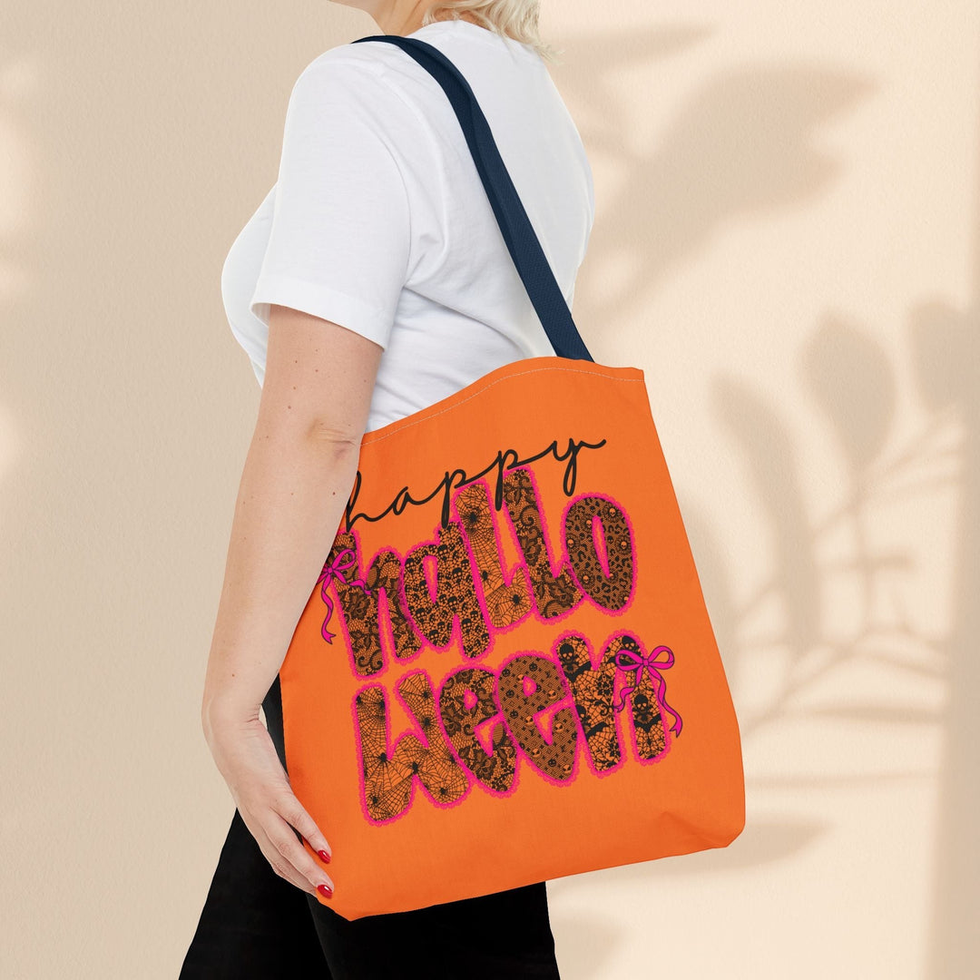Sea Dragon Dreams Happy Halloween tote bag in orange with black text and spiderweb pattern, worn over the shoulder.