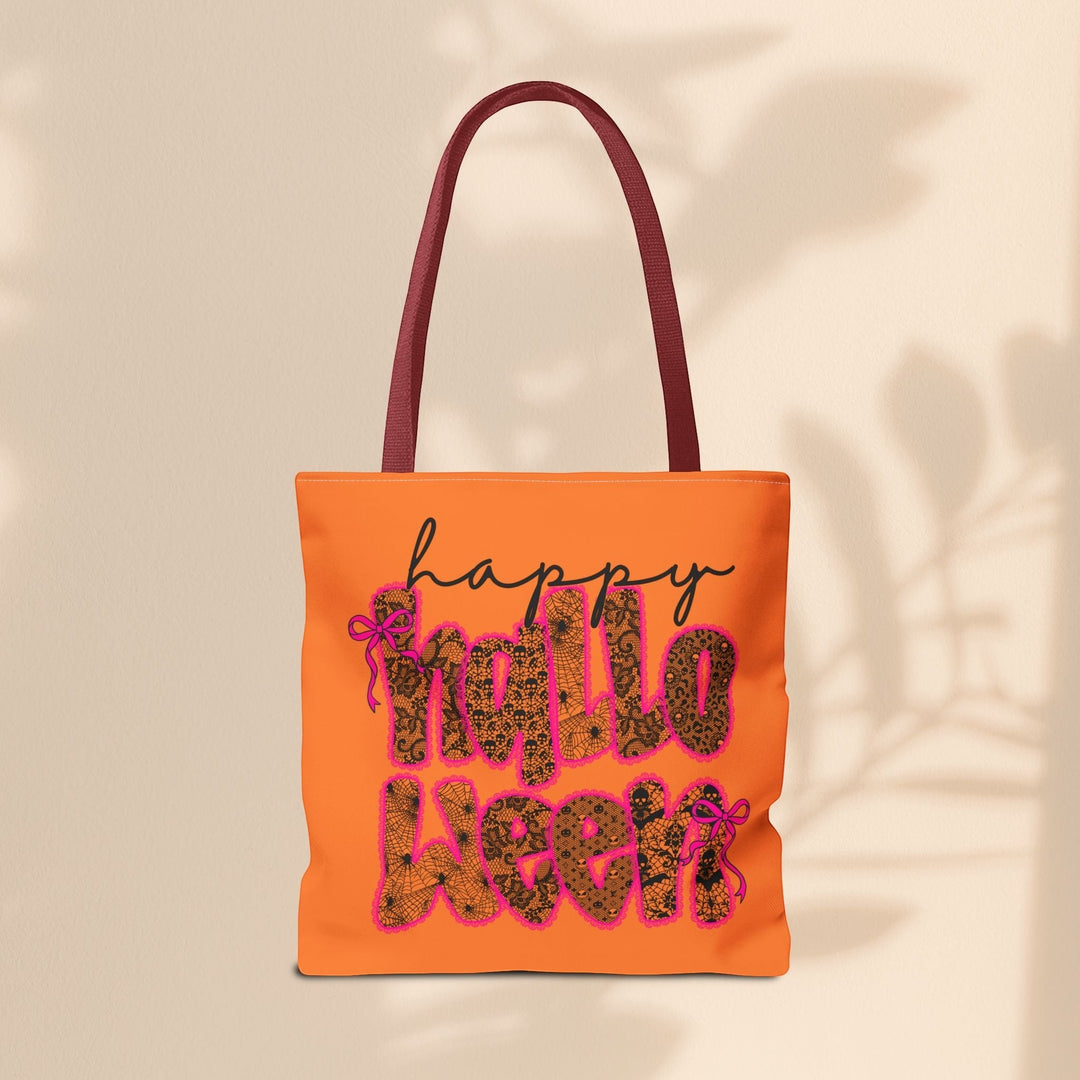 Sea Dragon Dreams orange polyester tote bag with Happy Halloween text in leopard and spiderweb print with pink bows.