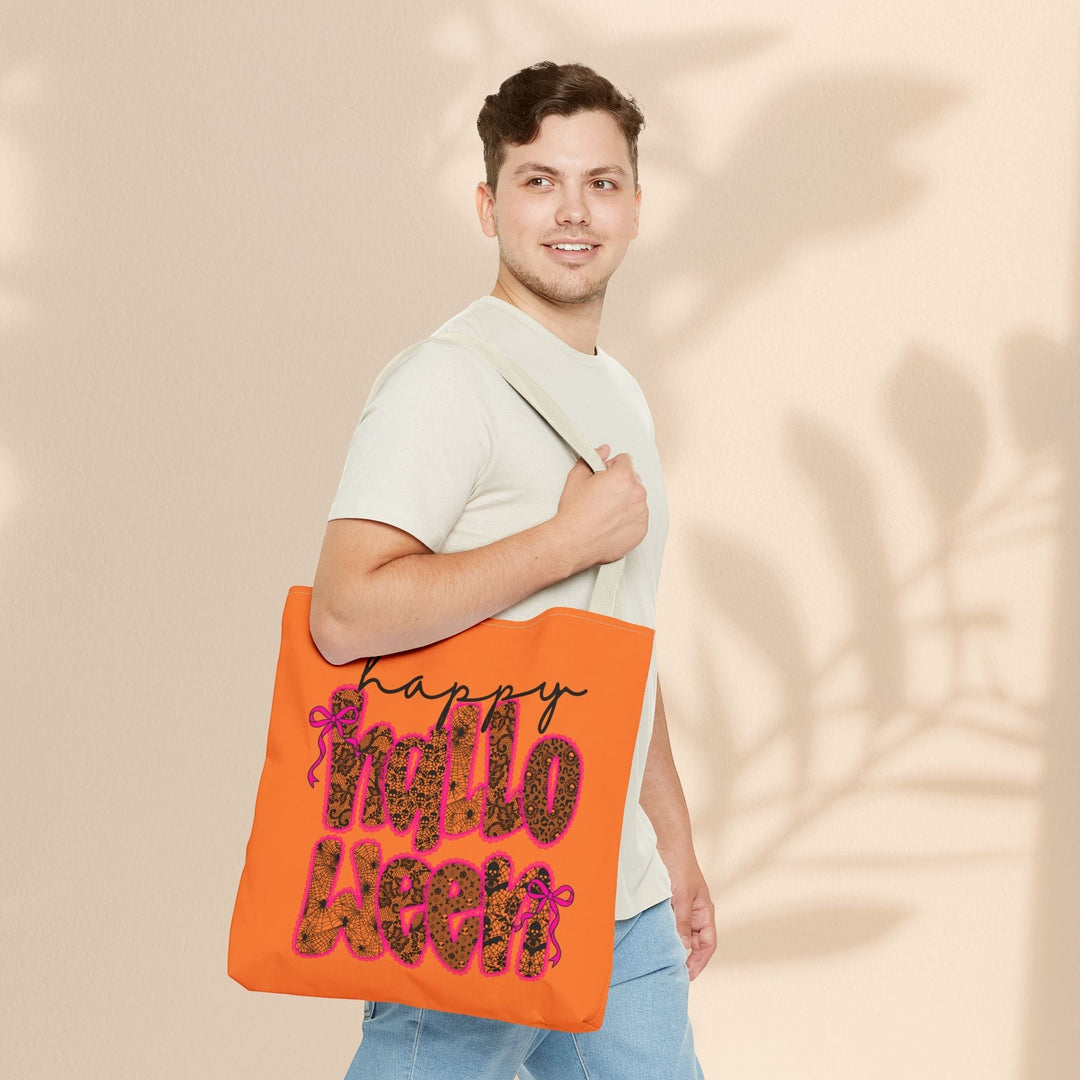 Man carrying a Sea Dragon Dreams orange Happy Halloween tote bag with leopard print lettering and pink bow accents.