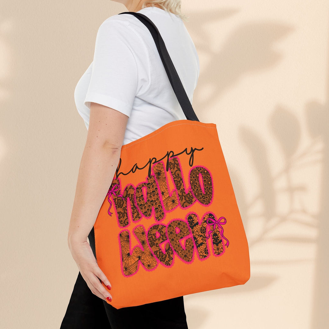 Sea Dragon Dreams Happy Halloween tote bag with orange fabric and black spiderweb text carried over a shoulder.