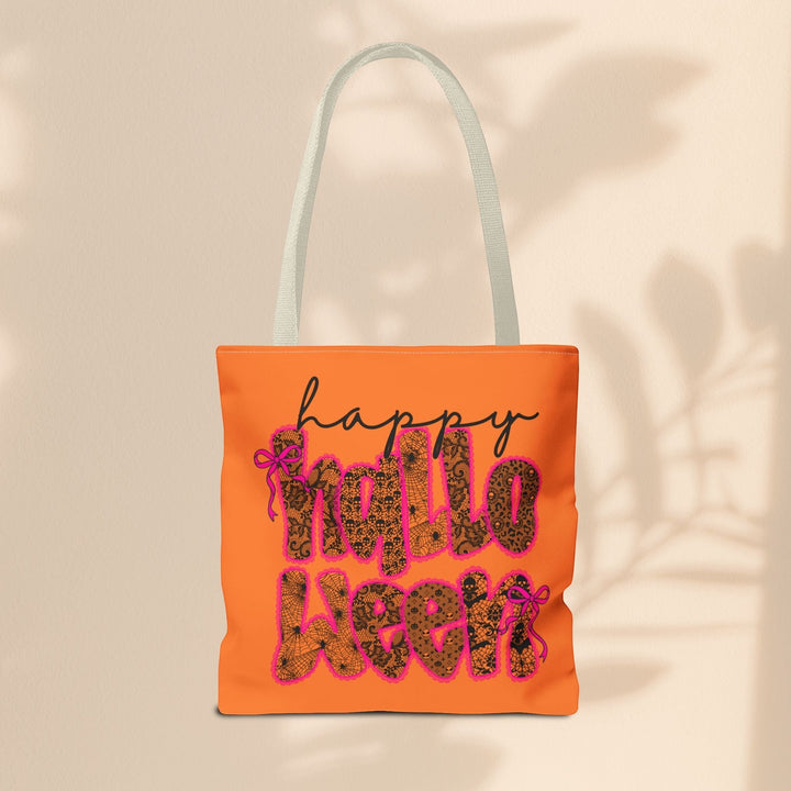 Sea Dragon Dreams Happy Halloween tote bag in orange with black lace-patterned text and pink ribbon accents.