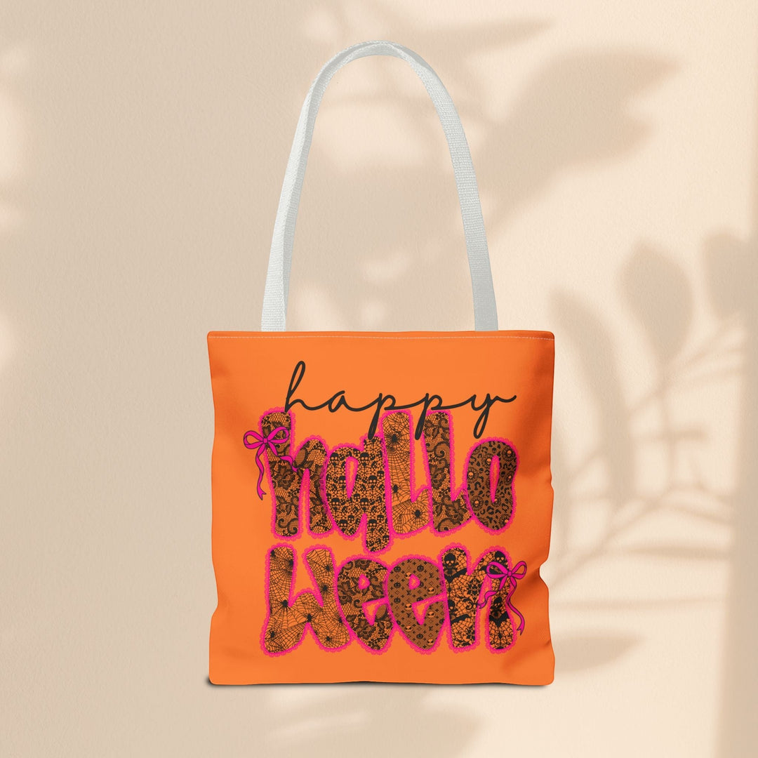 Sea Dragon Dreams orange polyester tote bag with Happy Halloween text in a black lace pattern and pink bow accents.