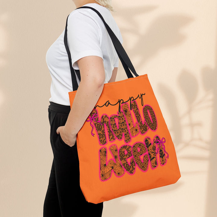 Sea Dragon Dreams orange Happy Halloween tote bag with black text and spiderweb pattern worn over the shoulder.