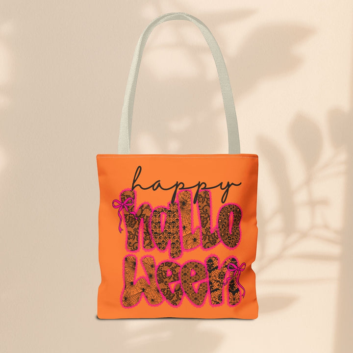 Sea Dragon Dreams orange polyester tote bag with Happy Halloween text in black lace pattern and pink bows