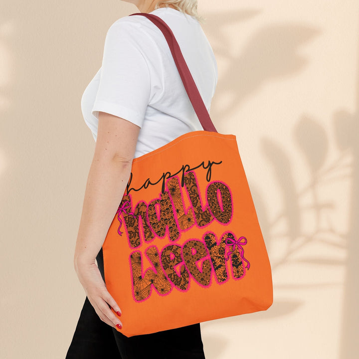 Sea Dragon Dreams Happy Halloween tote bag with orange fabric and leopard print lettering worn over the shoulder.