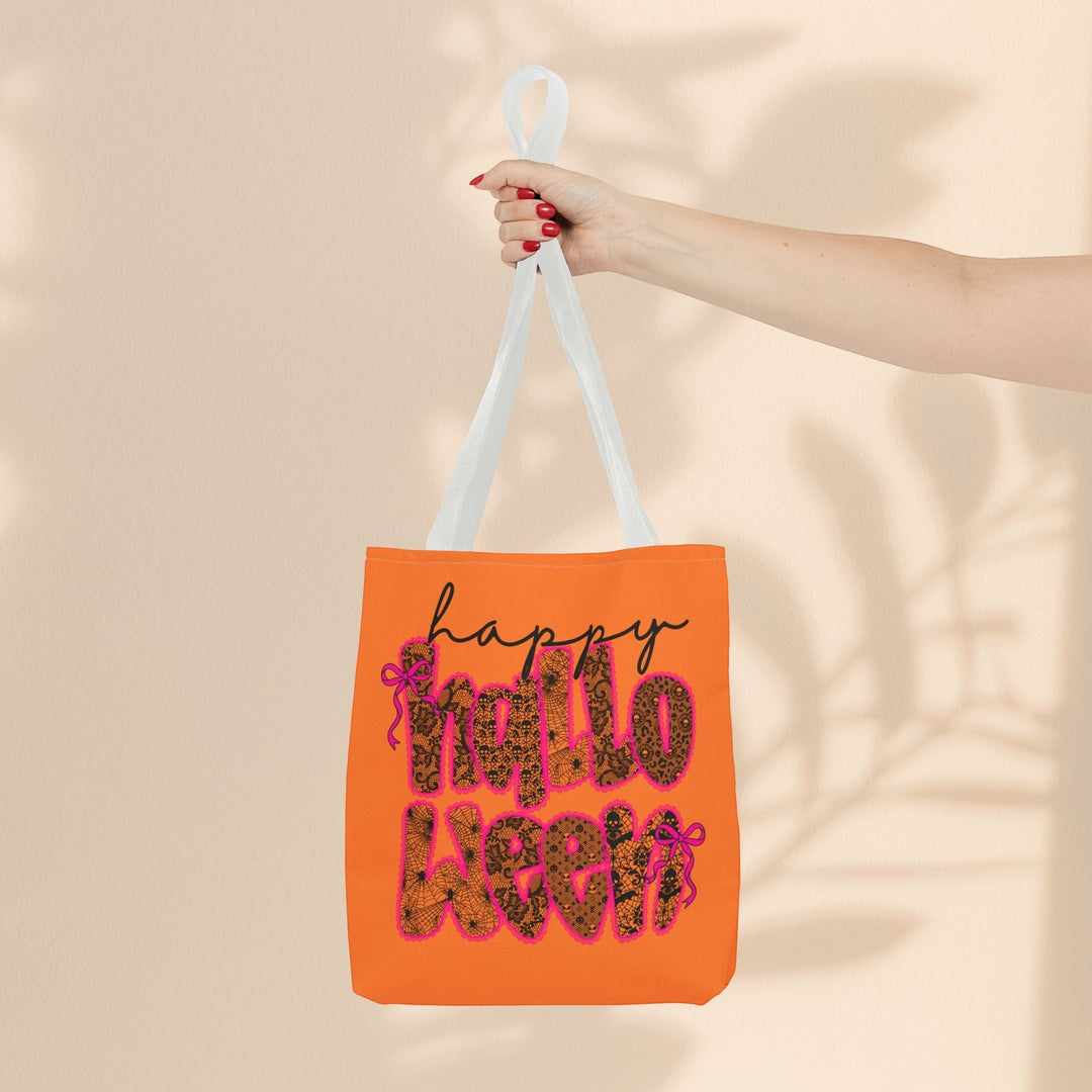 Sea Dragon Dreams orange polyester tote bag with Happy Halloween text and leopard print pattern held by a hand.