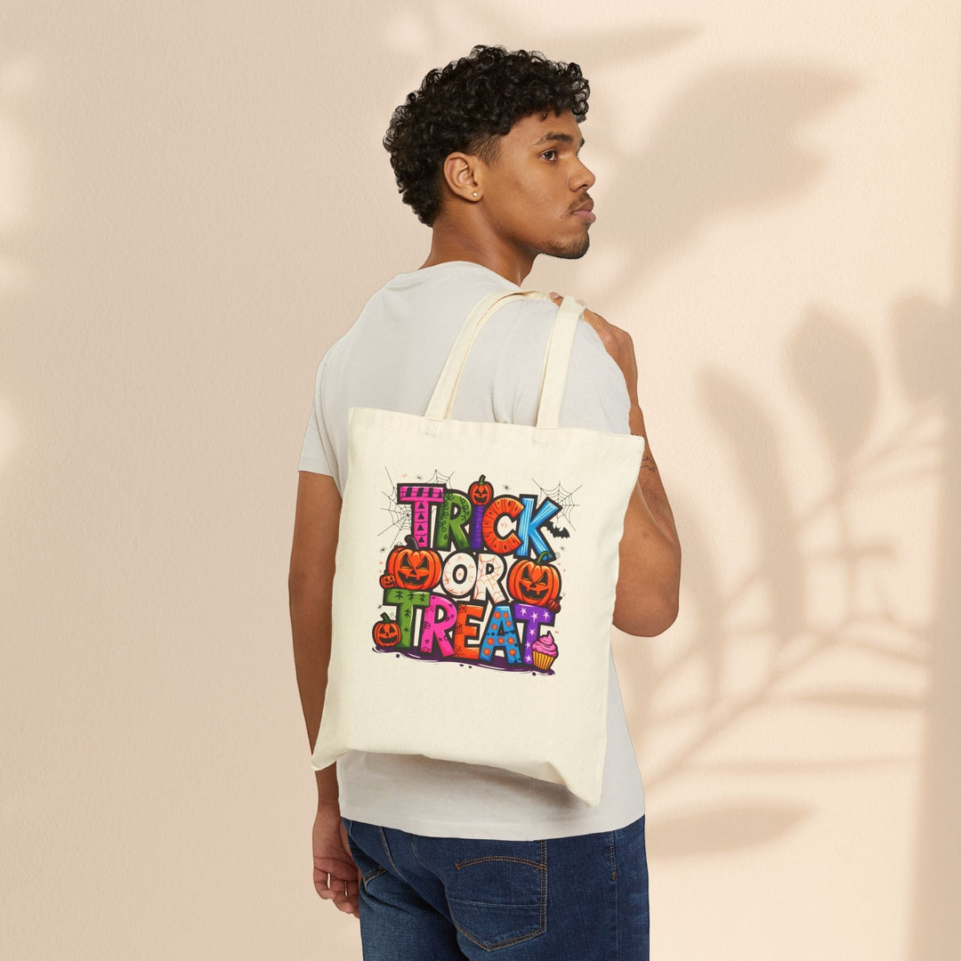 Sea Dragon Dreams natural cotton canvas tote bag with colorful Halloween Trick or Treat print worn over the shoulder