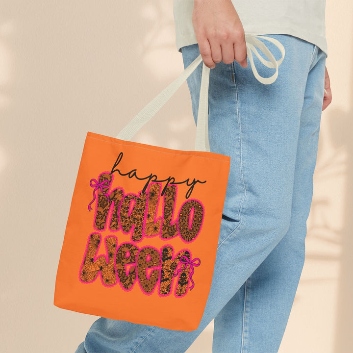 Sea Dragon Dreams orange polyester Halloween tote bag with leopard print lettering and pink bows held by a person.