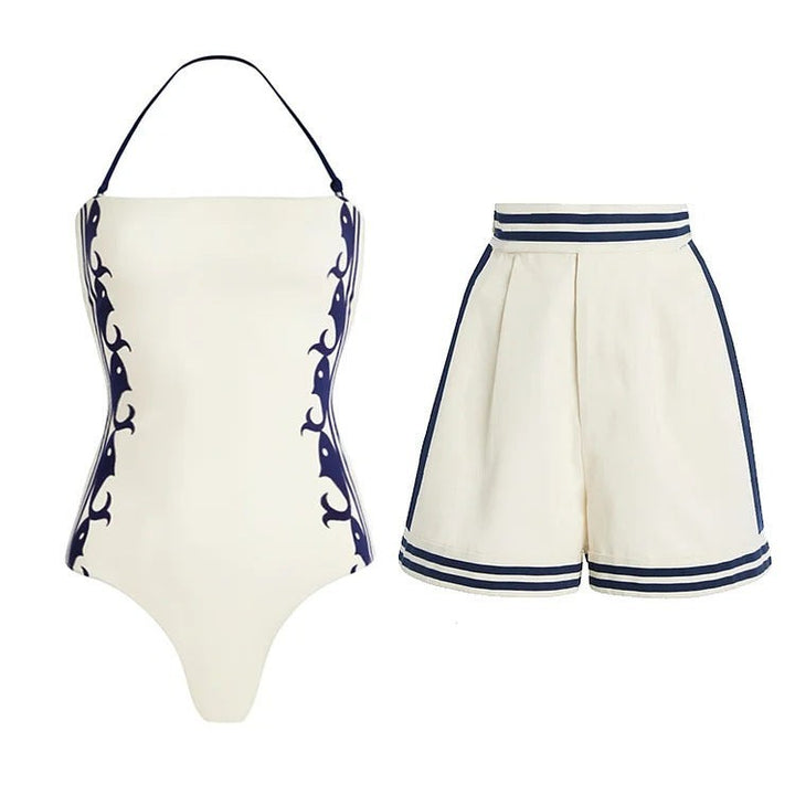 Sea Dragon Dreams cream and navy halter one-piece swimsuit with matching high-waisted shorts for a classic beach look.