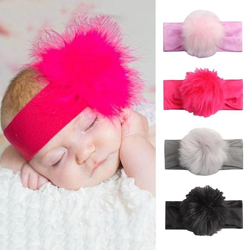 Sea Dragon Dreams handmade baby headband with a fluffy pom-pom, worn by a sleeping infant in various vibrant colors.