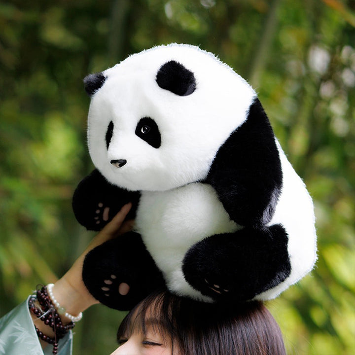 Sea Dragon Dreams handmade plush Hehua panda backpack with realistic black and white fur worn on a person's head.