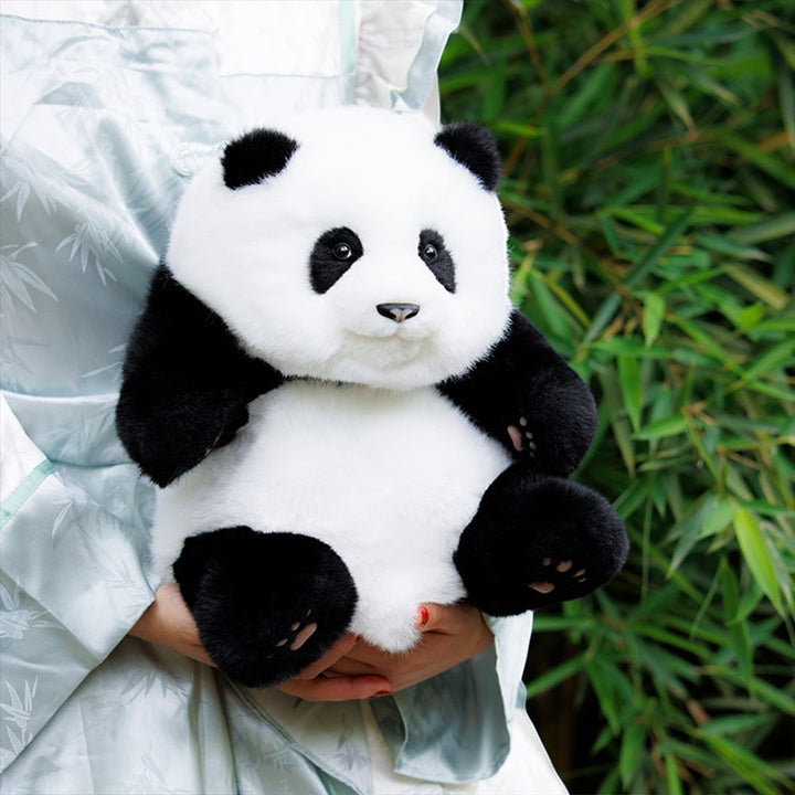 Sea Dragon Dreams handmade plush Hehua panda mini backpack with realistic black and white fur held by a person