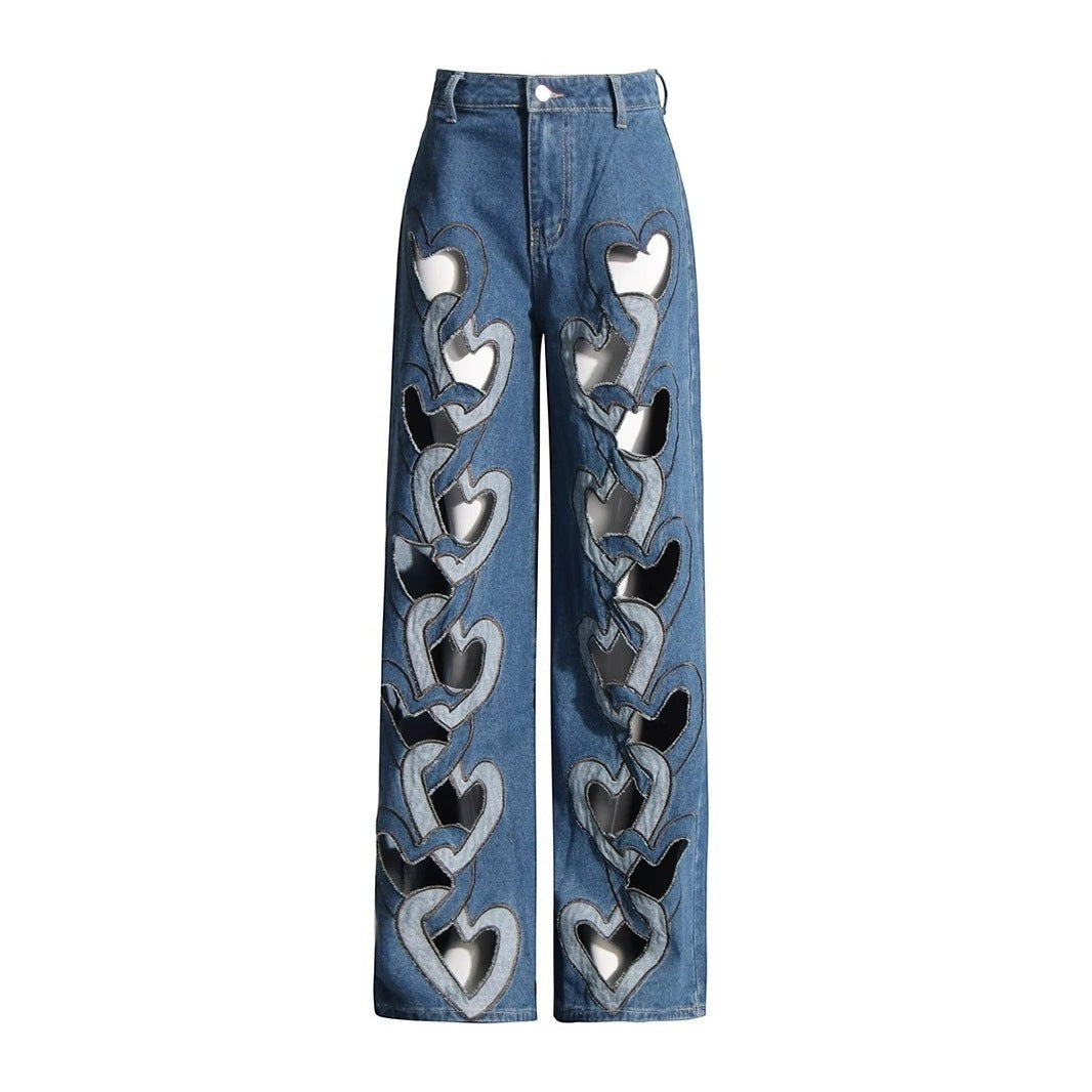 Sea Dragon Dreams high-waisted blue denim jeans with a wide-leg fit and repeating heart-shaped cutout details.