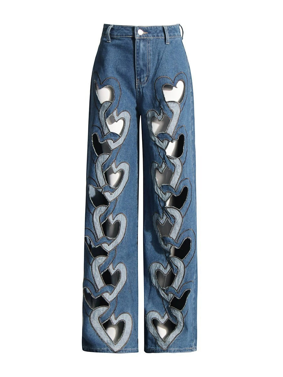 Sea Dragon Dreams high-waisted blue denim jeans with a wide-leg fit and repeating heart-shaped cutout details.