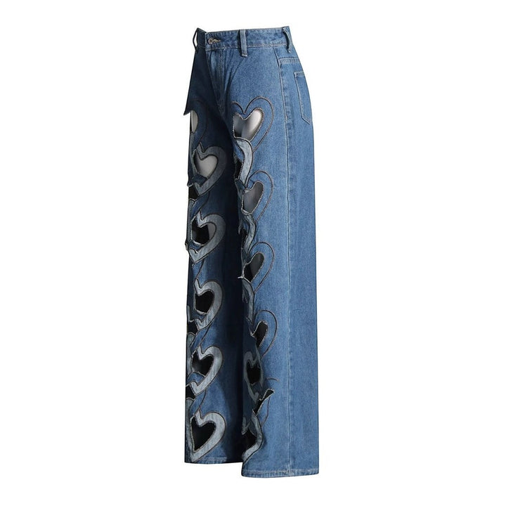 Sea Dragon Dreams high-waisted blue denim jeans with a wide-leg fit and multiple heart-shaped cutouts along the sides.