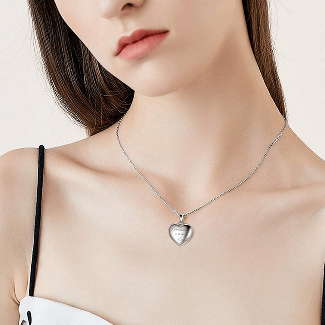 Sea Dragon Dreams stainless steel heart locket necklace worn by a woman, featuring a custom photo compartment.