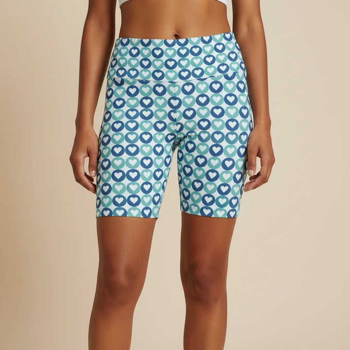 Sea Dragon Dreams women's workout shorts featuring a blue and teal heart pattern, made from quick-dry polyester.
