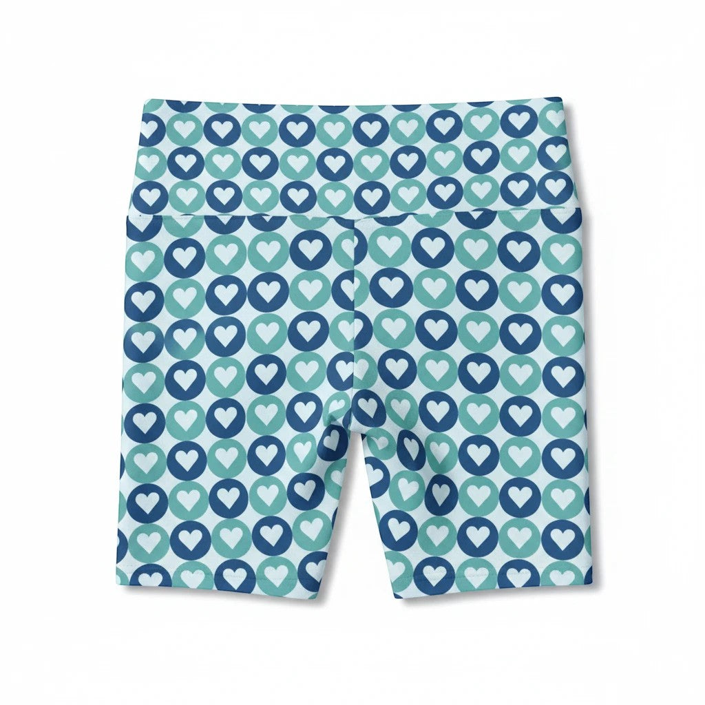 Sea Dragon Dreams women's workout shorts in polyester with a blue and teal heart pattern and comfortable elastic waist.