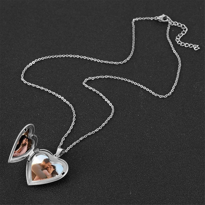 Sea Dragon Dreams stainless steel heart locket necklace open to reveal two custom photos on a black background