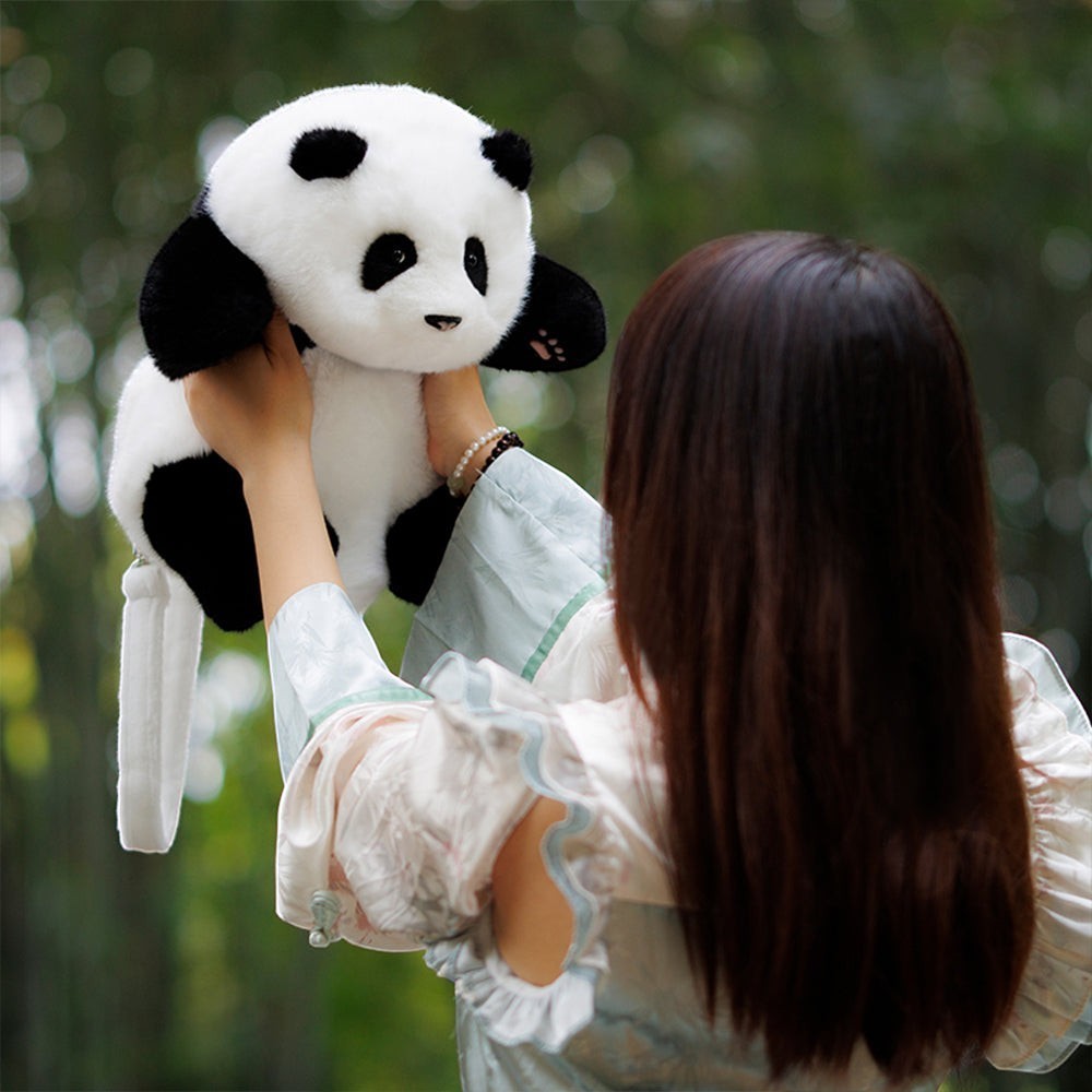 Sea Dragon Dreams Hehua panda plush mini backpack held up by a person, featuring soft black and white fur details.