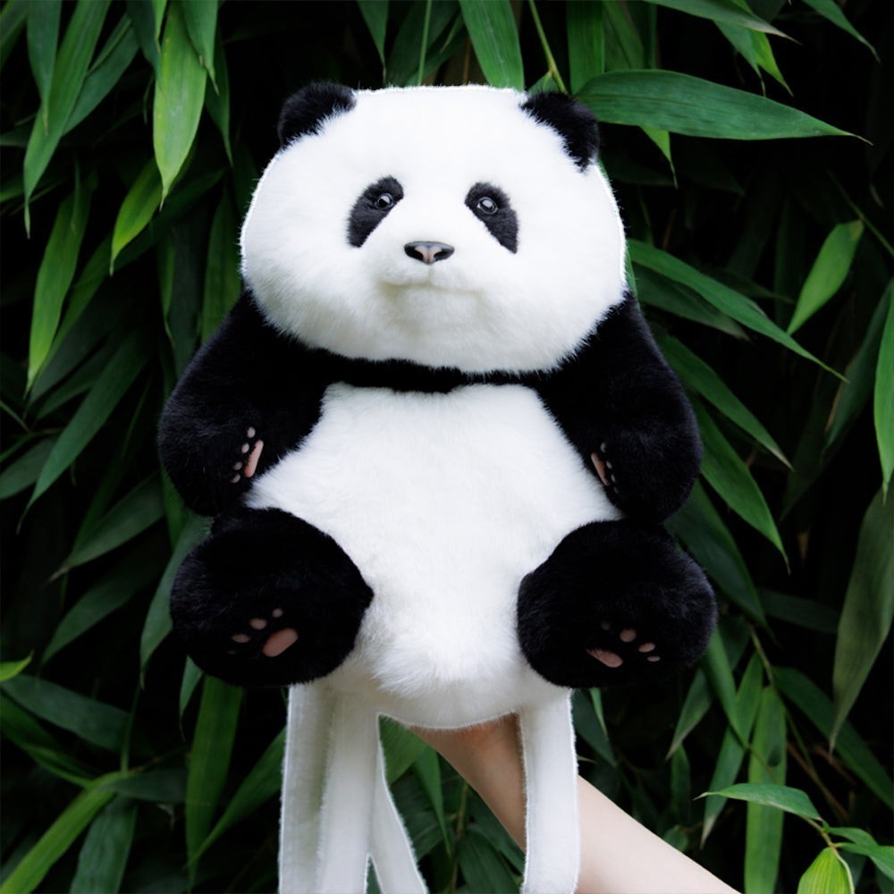 Sea Dragon Dreams Hehua panda mini backpack made of soft black and white plush fabric against a bamboo background.