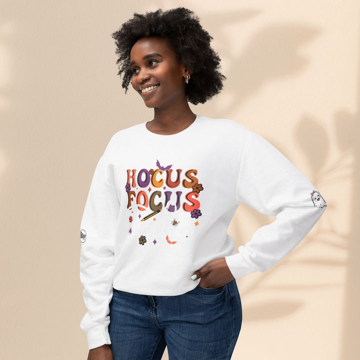 Sea Dragon Dreams white crewneck sweatshirt with Hocus Focus teacher graphic, worn by a smiling woman in jeans.