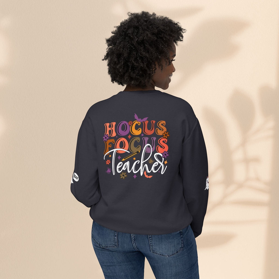 Sea Dragon Dreams unisex crewneck sweatshirt in dark grey with Hocus Focus Teacher graphic on back, worn by model.