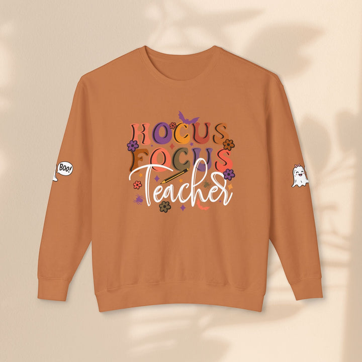 Sea Dragon Dreams unisex crewneck sweatshirt in burnt orange with Hocus Focus Teacher Halloween graphic and sleeve art