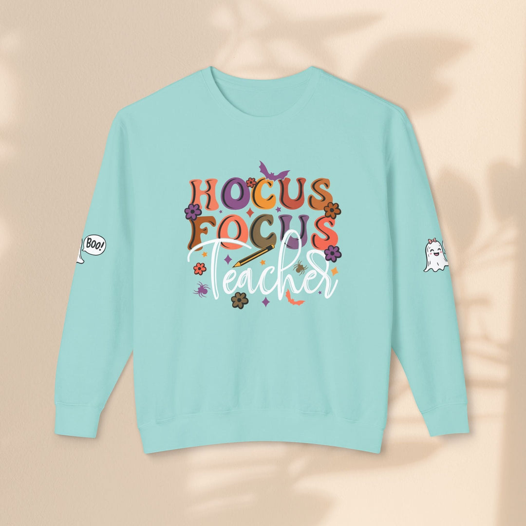 Sea Dragon Dreams light blue crewneck sweatshirt with Hocus Focus Teacher graphic, ghost, and bat Halloween motifs.