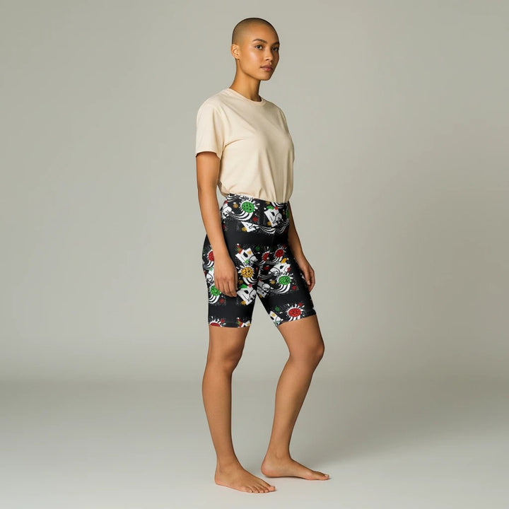 Model wearing Sea Dragon Dreams holiday pickleball print workout shorts with a beige t-shirt in a studio setting