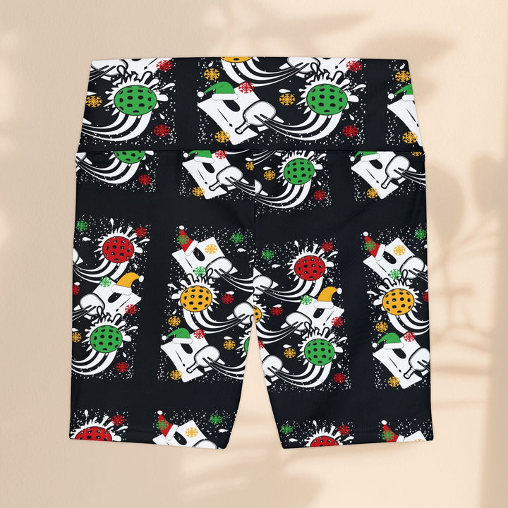Sea Dragon Dreams women's workout shorts with a festive holiday pickleball print on black moisture-wicking fabric.