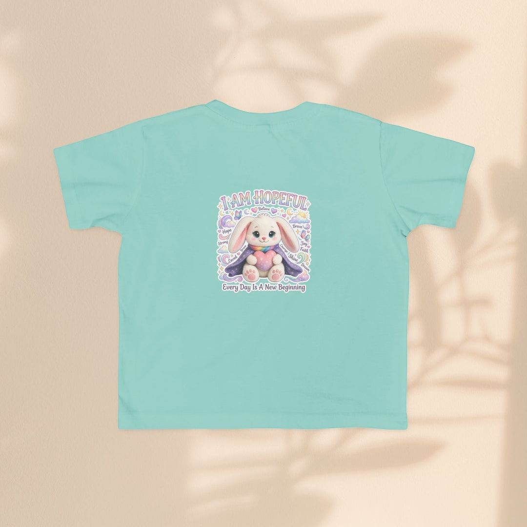 Sea Dragon Dreams toddler tee in light teal cotton featuring the Brave Buddies Hope Bunny graphic and I Am Hopeful text