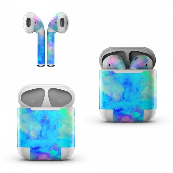 Sea Dragon Dreams ice blue vinyl skin on Apple AirPods and charging case with vibrant watercolor aesthetic.