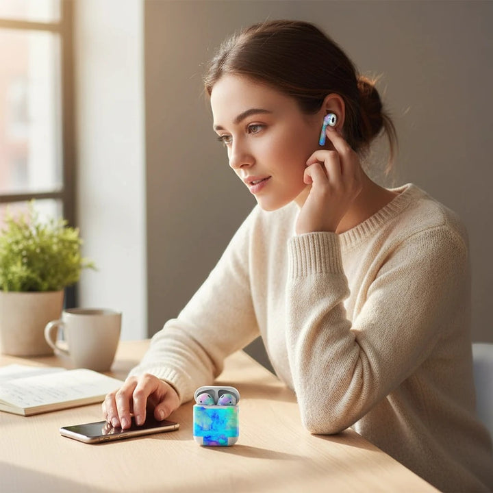 Woman wearing Electrify Ice Blue vinyl skin on Apple AirPods while sitting at a desk with the matching case