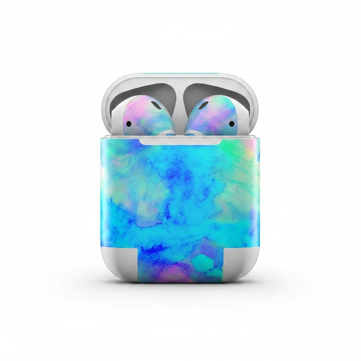 Sea Dragon Dreams Electrify Ice Blue vinyl skin on Apple AirPods charging case with a vibrant watercolor aesthetic.
