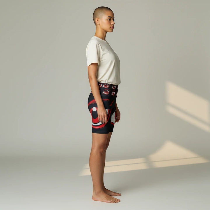 Model wearing Sea Dragon Dreams I'm Watching workout shorts with a bold eye print, side view, 100% polyester fabric.