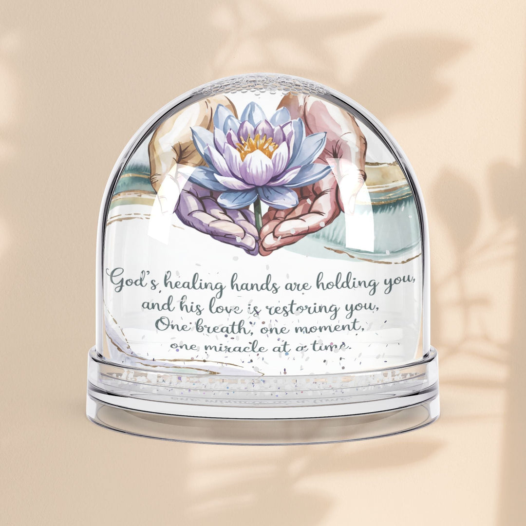 Sea Dragon Dreams inspirational snow globe featuring a lotus flower and the message God's Healing Hands Are Holding You