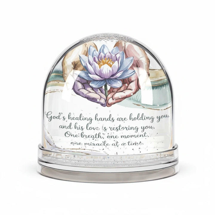 Sea Dragon Dreams inspirational snow globe featuring a lotus flower held in hands with a healing prayer message.