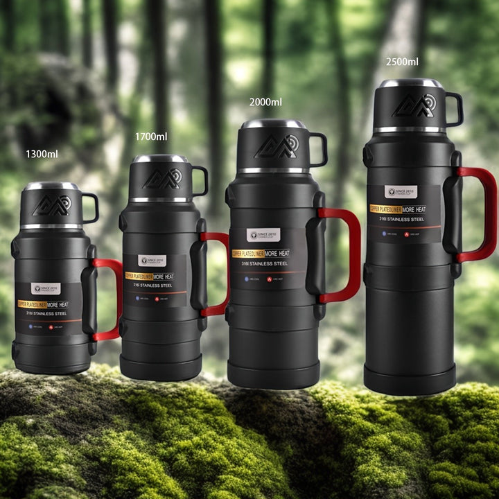 Sea Dragon Dreams black stainless steel insulated water bottles in four sizes with red handles and lids in a forest.