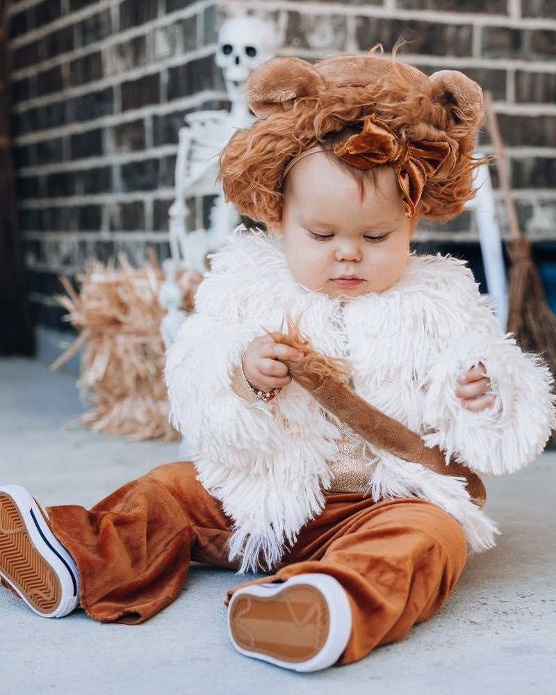 Sea Dragon Dreams ivory faux shag layered jacket worn by a toddler with a brown velvet bow headband